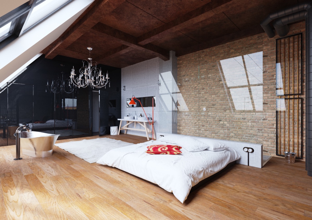 low-lying-bed-chandelier-exposed-brick-bedroom 