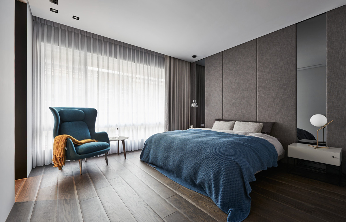 teal-chair-grey-wall-panels-modern-bedroom