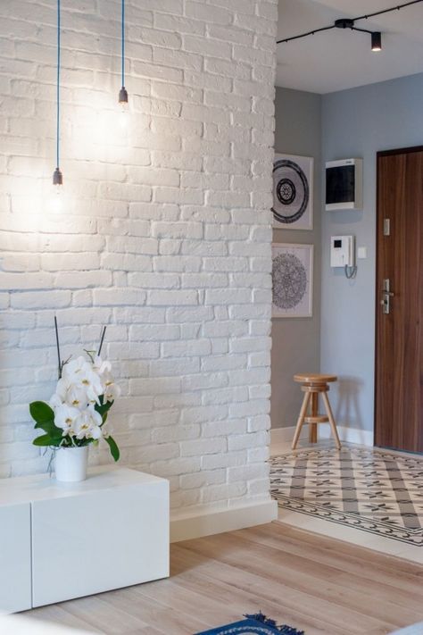beautiful entrance room with white exposed brick wall
