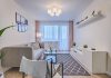 Small living room with sofa, carpet, chair and curtains