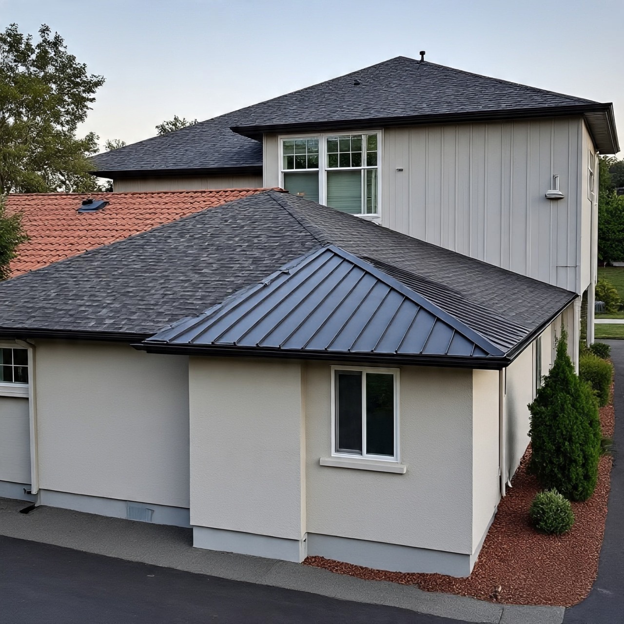 Modern home with metal roof, asphalt shingles, and clay tile roofing materials